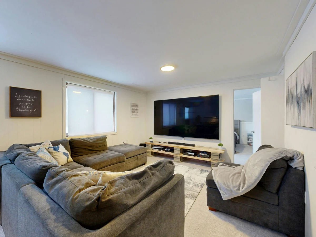 Couple watching IPTV on a large TV connected to Apple TV 4K