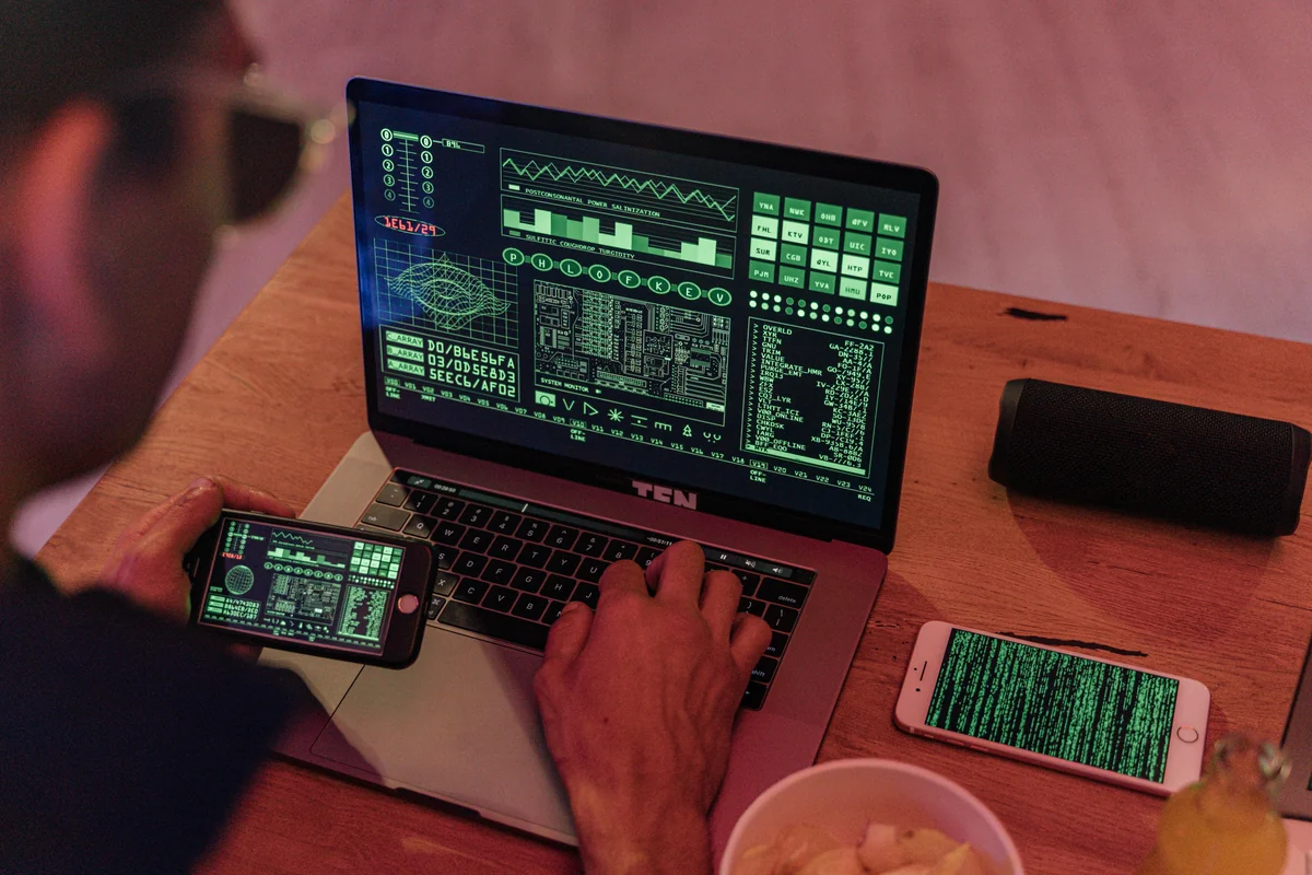 Young man using smartphone and watching TV simultaneously — multi-device IPTV setup