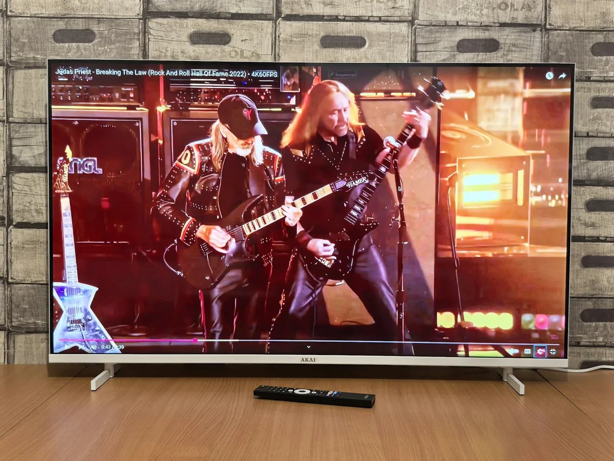 Family watching a large smart TV in a modern living room — IPTV vs cable TV in 2026