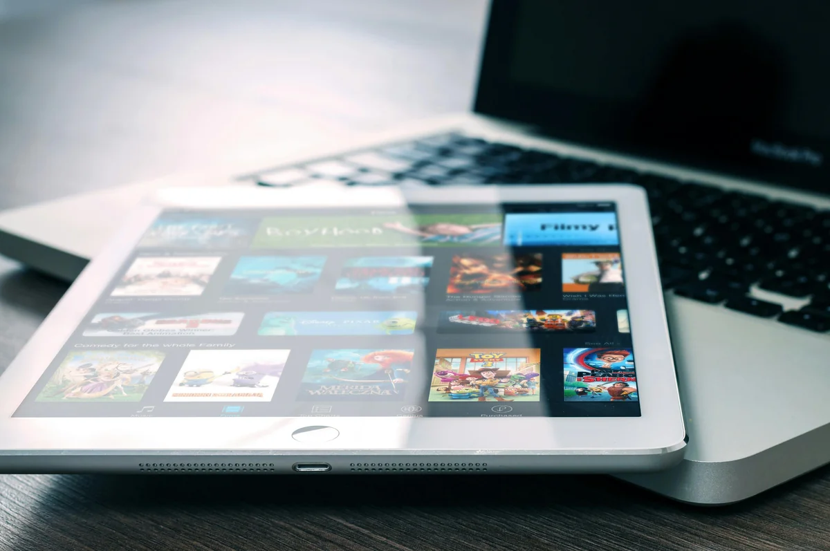Couple watching content together on a tablet on the sofa — IPTV synced across all household devices